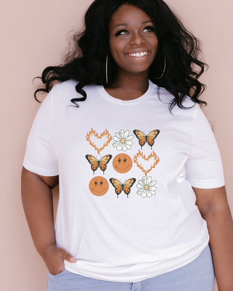 Front of a model wearing a size XL Butterfly Smiley Face Short Sleeve Graphic Tee in White by Simply Sage Market. | dia_product_style_image_id:283214